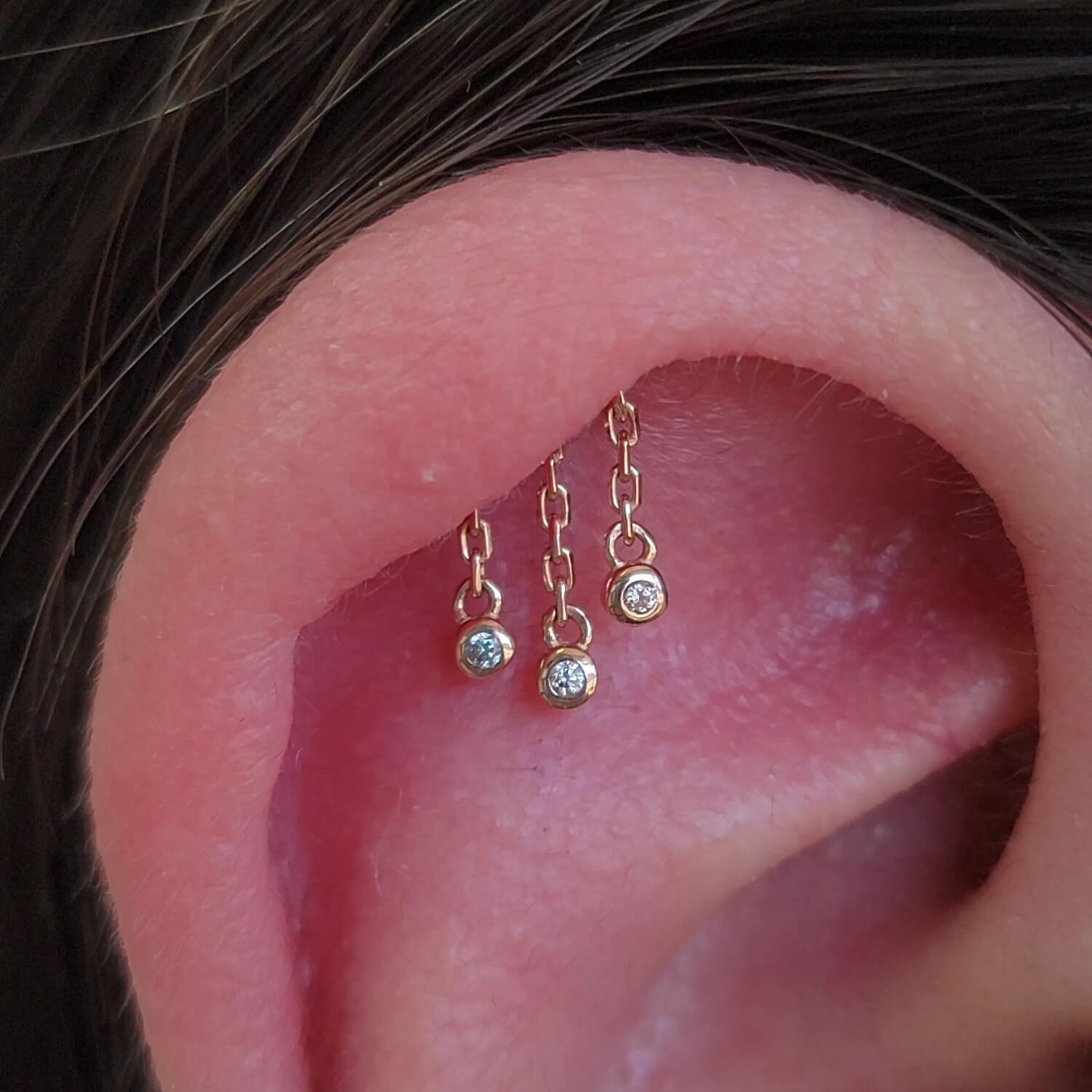 Helix piercing done with 14k yellow gold